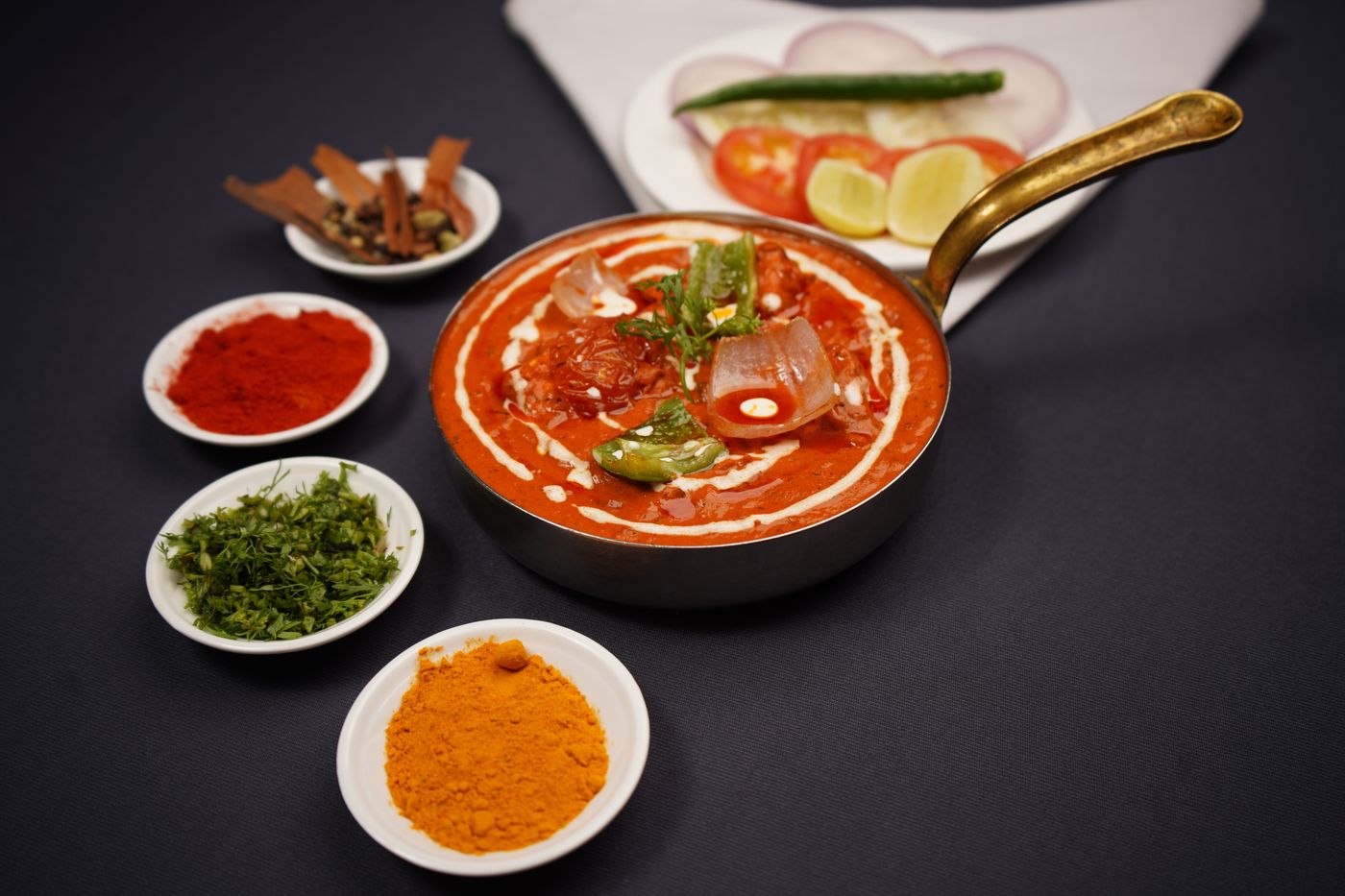 Indian curry presented with fresh herbs and spices