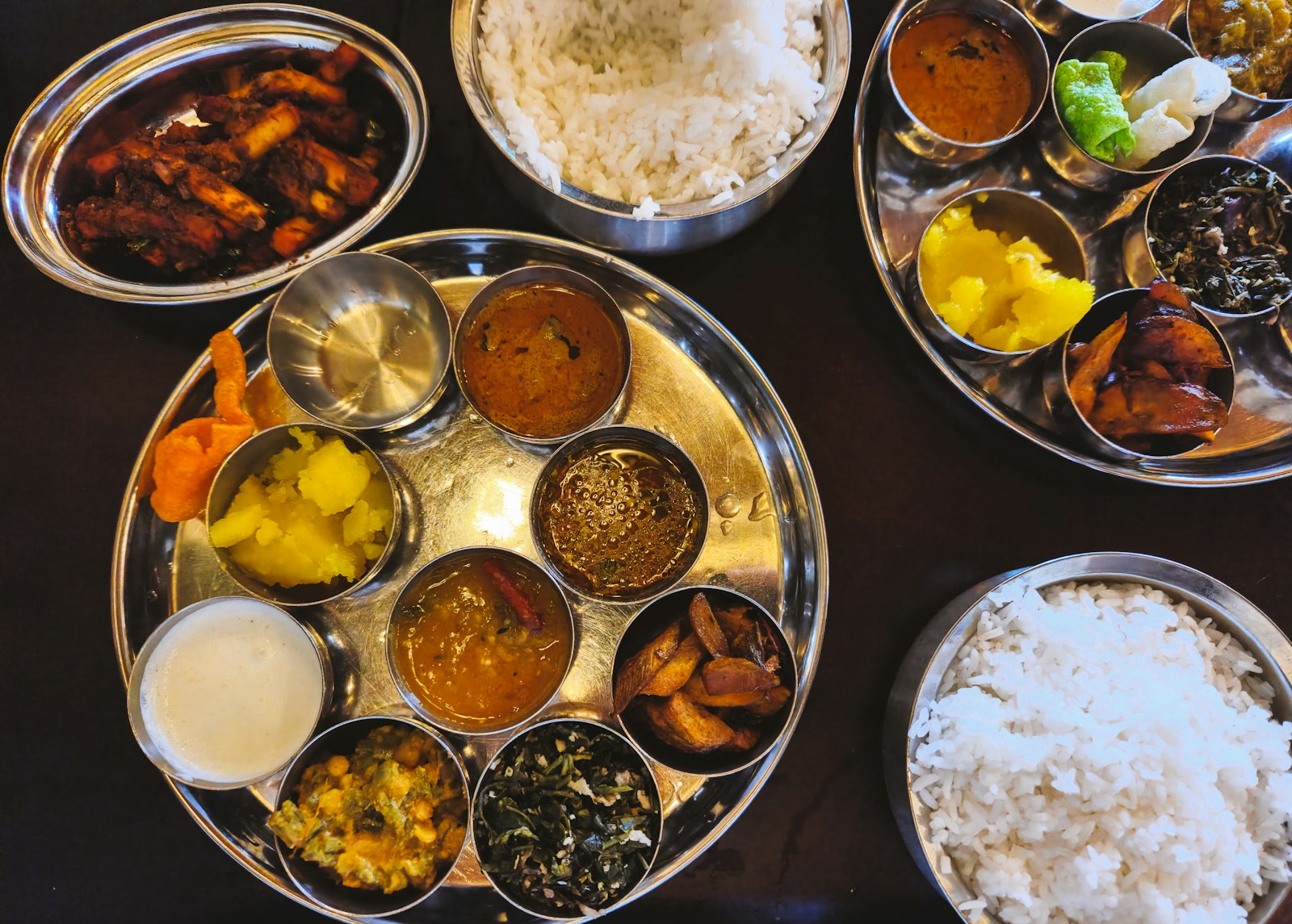 An abundant Indian thali with rice, curries and accompaniments